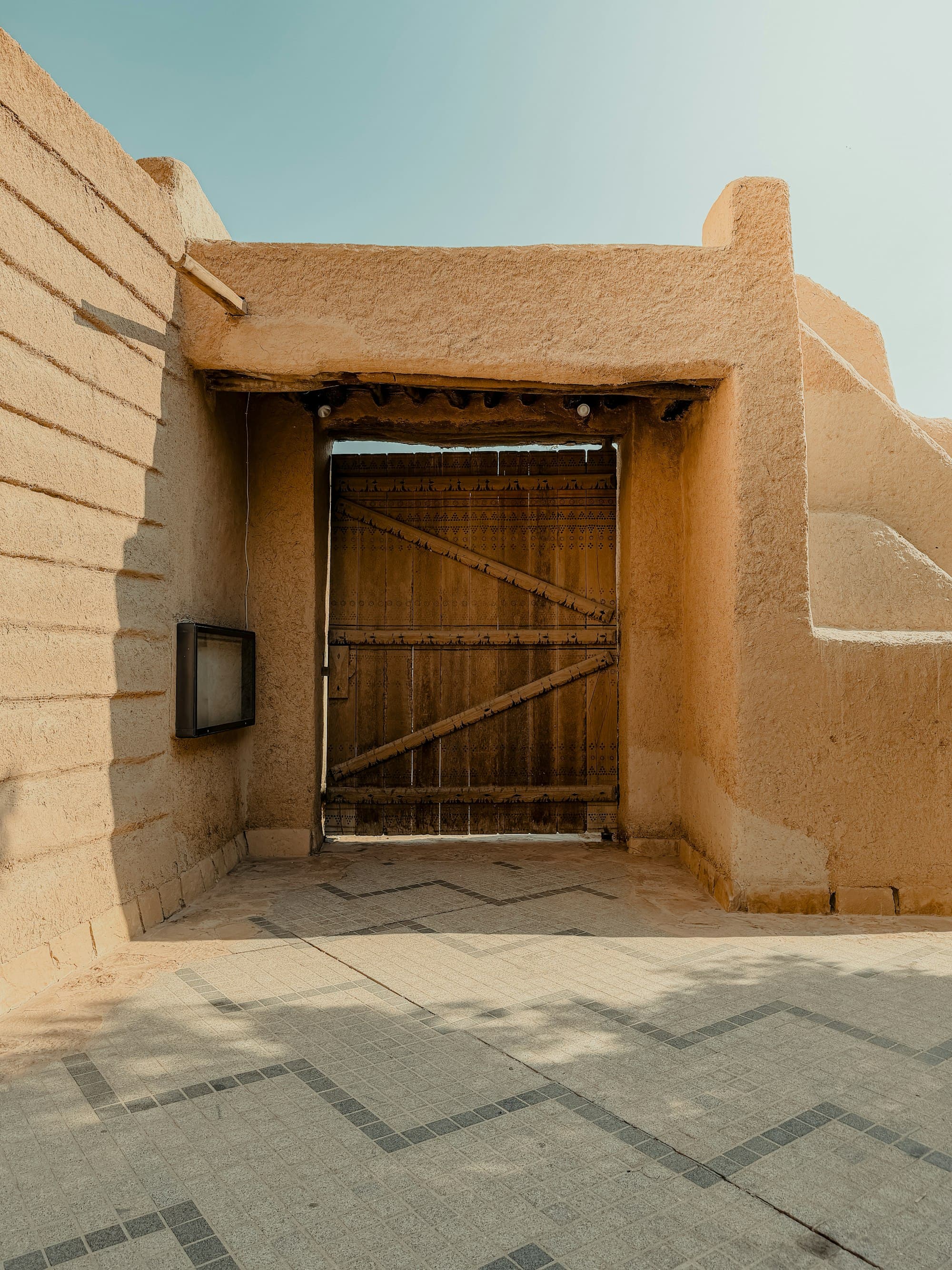 Wooden door in a Najdi mud-brick wall, Diriyah
